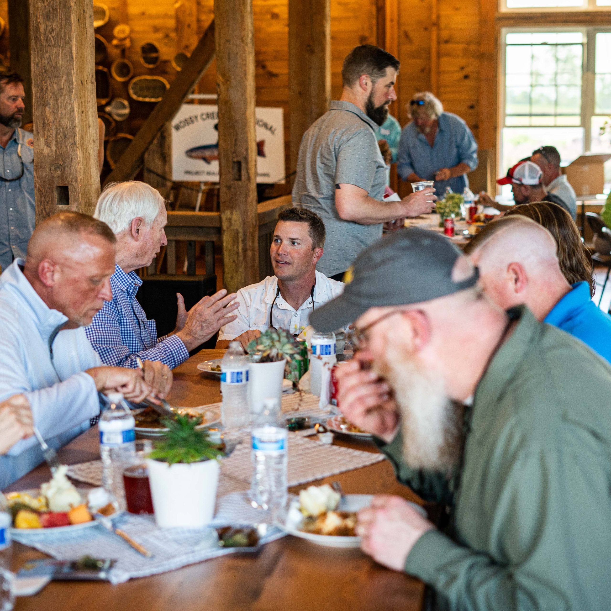 People eating lunch in a barn
