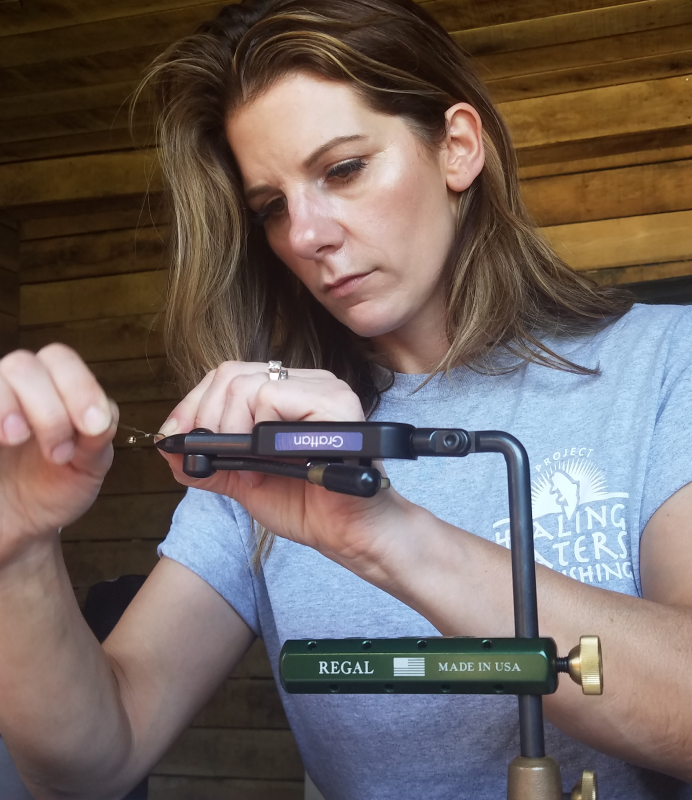 A woman making a fishing hook